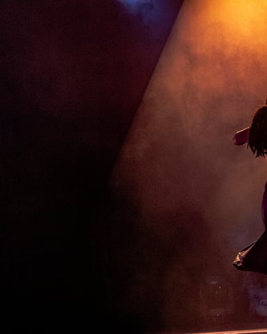Dancer on stage under warm spotlight