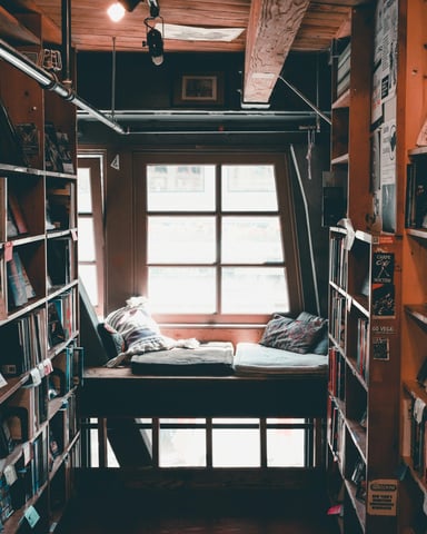 Cozy bookstore with window seat and packed shelves