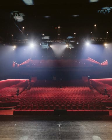 Empty red-seat theater viewed from the stage
